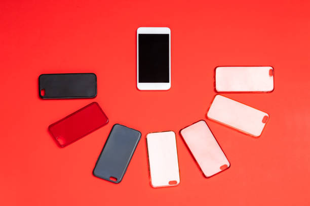 istock Choice of multicolored plastic back covers for mobile phones on red background with a smart phone on the side 1464482218
