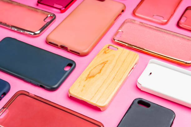 istock Pile of multicolored plastic back covers for mobile phone. Choice of smart phone protector accessories on pink background. A lot of silicone phone backs or skins next to each other 1464482220