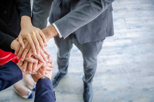 istock close up business people putting their hands together.Unity and teamwork concept 1464482755