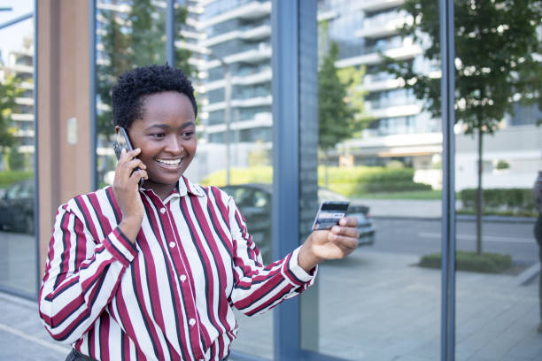 istock Cheerful  young woman doing online shopping 1464484476