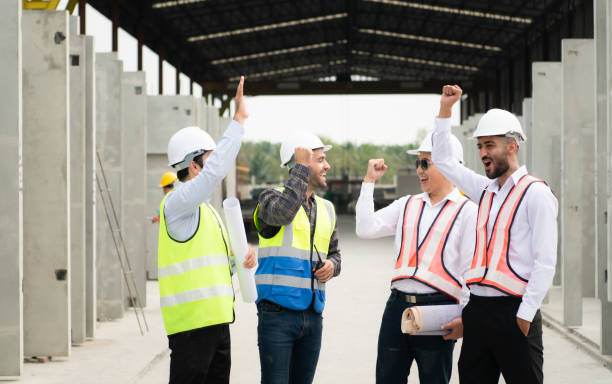 istock Construction engineers, architects, and foremen form a group. Participate in a meeting to plan new construction projects. Cheers to express happiness that the event was successfully accomplished. 1464484749