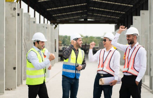 istock Construction engineers, architects, and foremen form a group. Participate in a meeting to plan new construction projects. Cheers to express happiness that the event was successfully accomplished. 1464484756
