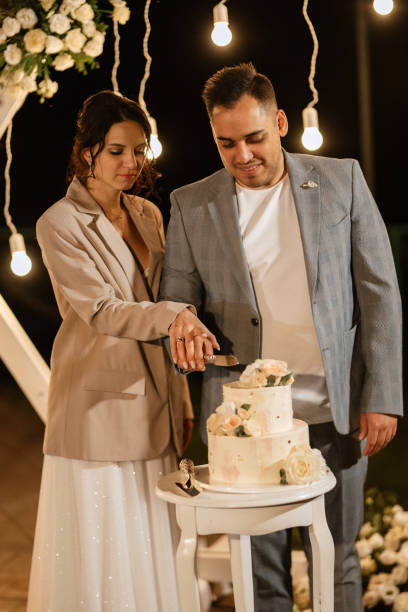 istock newlyweds happily cut and taste the wedding cake 1464484759