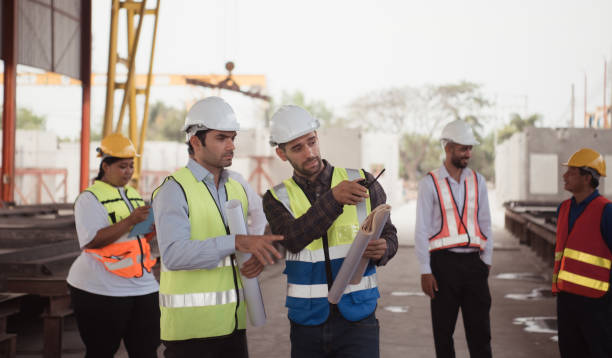 istock Group of architects, construction foremen, and construction engineers review the work and talk about how the project, in the construction site. 1464484760