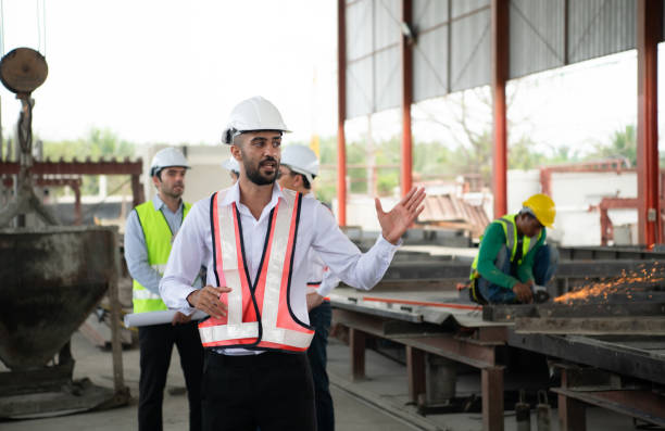 istock Group of architects, construction foremen, and construction engineers review the work and talk about how the project, in the construction site. 1464484795