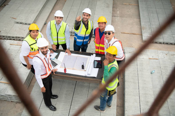 istock Construction engineers, architects, and foremen form a group. Participate in a meeting to plan new construction projects. 1464484856