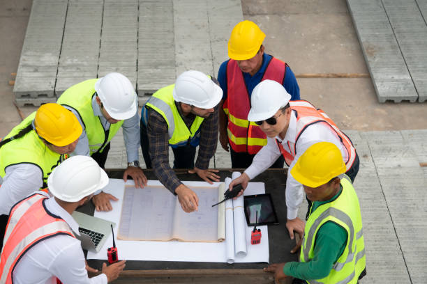 istock Construction engineers, architects, and foremen form a group. Participate in a meeting to plan new construction projects. 1464484898