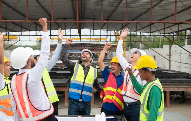 istock Construction engineers, architects, and foremen form a group. Participate in a meeting to plan new construction projects. Cheers to express happiness that the event was successfully accomplished. 1464484929