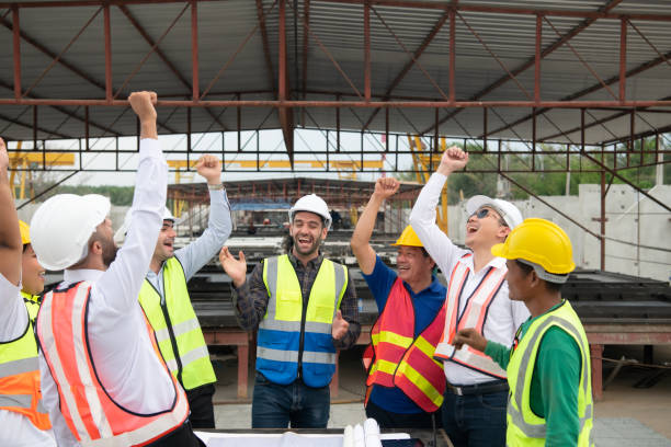 istock Construction engineers, architects, and foremen form a group. Participate in a meeting to plan new construction projects. Cheers to express happiness that the event was successfully accomplished. 1464484954