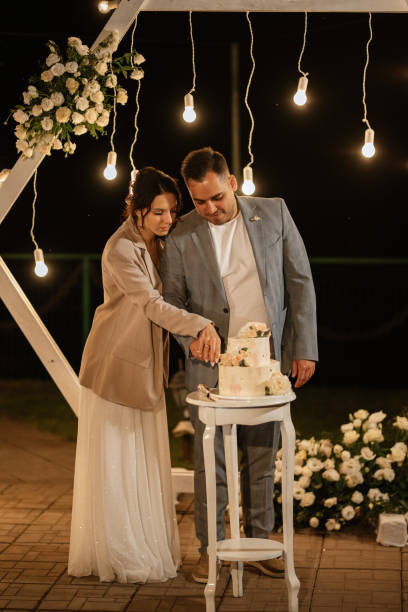 istock newlyweds happily cut and taste the wedding cake 1464484996