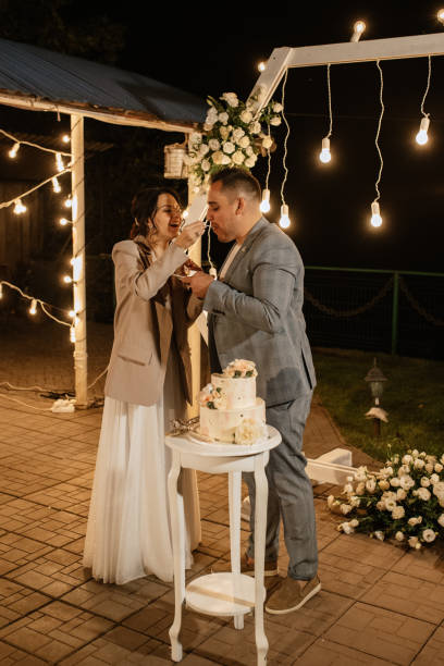istock newlyweds happily cut and taste the wedding cake 1464485021