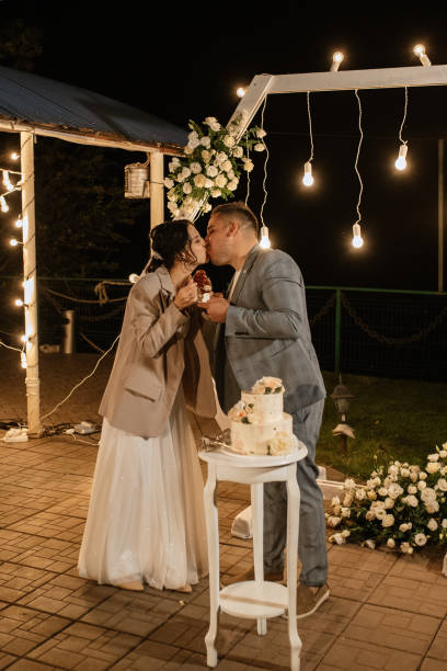 istock newlyweds happily cut and taste the wedding cake 1464485048