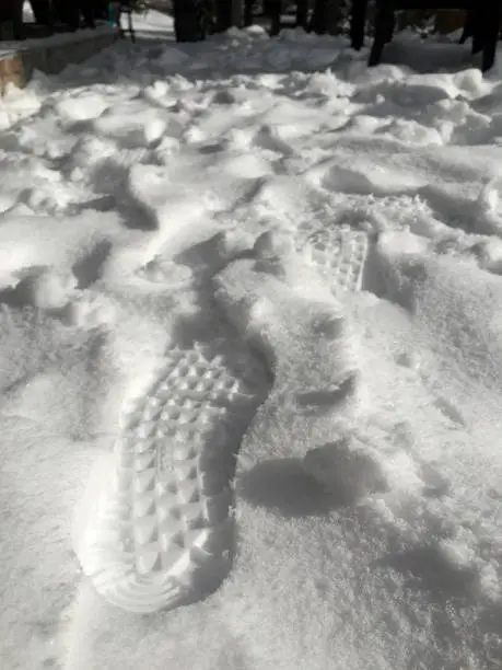 Footprint on snowy road