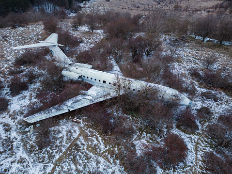 abandoned crashed passenger plane wreck in the forest in winter