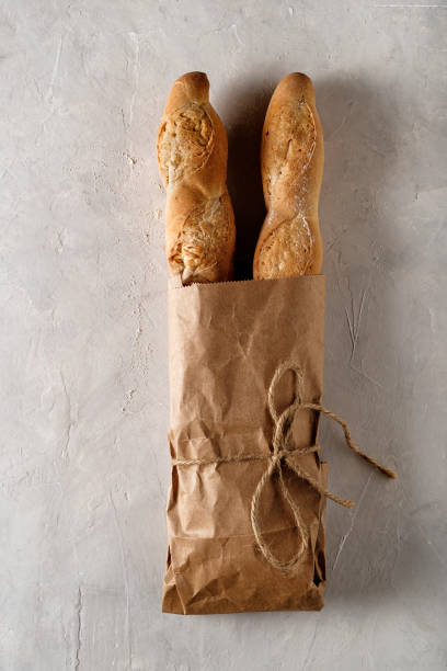 istock Freshly baked baguette on bright background, top view 1464489814