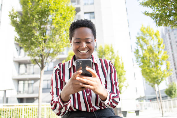 istock Happy young woman using phone 1464489838