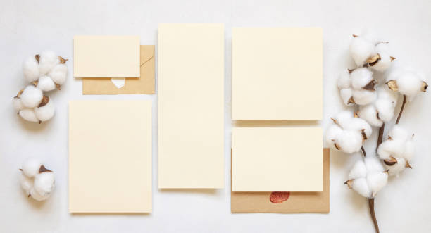 istock Blank cards and envelope with cotton flowers top view on white, wedding mockup 1464490510