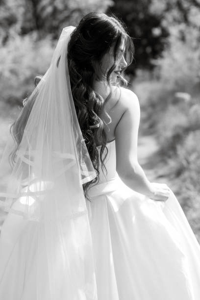 istock a young girl bride in a white dress is spinning on a path 1464491465
