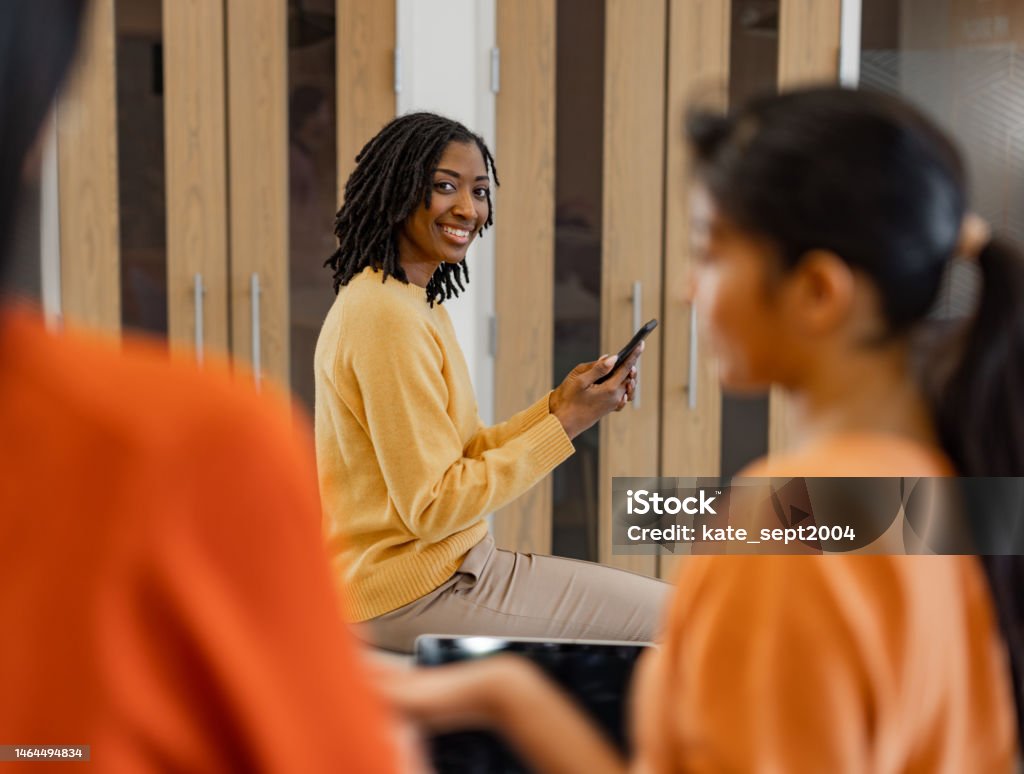 Healthy workplaces How the psychology of the office can affect employees A young woman is using her smartphone - stock photo 25-29 Years Stock Photo