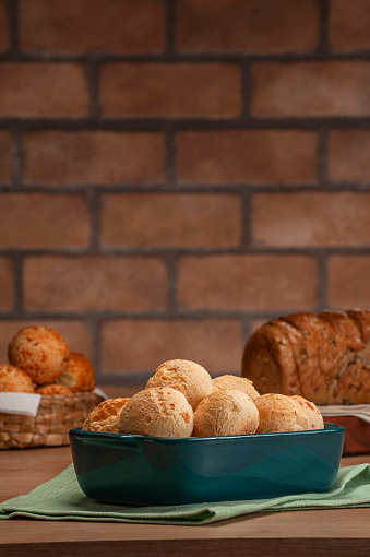 Cheese breads in a serving dish with breads behinden.