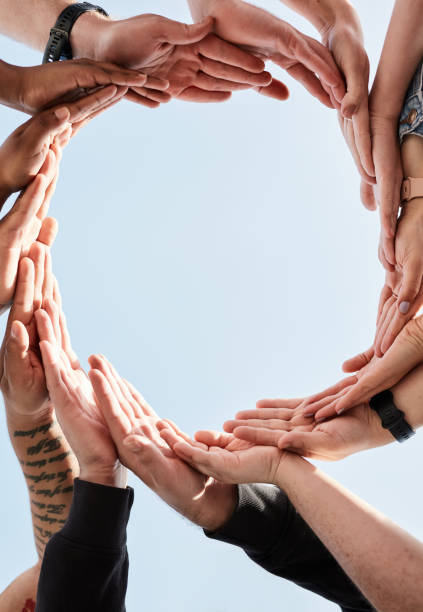istock Hands in circle, blue sky and sun, diversity and community in collaboration for global support and success. Teamwork, hand and summer sunshine, positive vision and trust in group of friends with love 1464496993