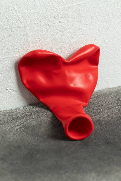 istock Deflated red balloon. Heart shape. 1464497197
