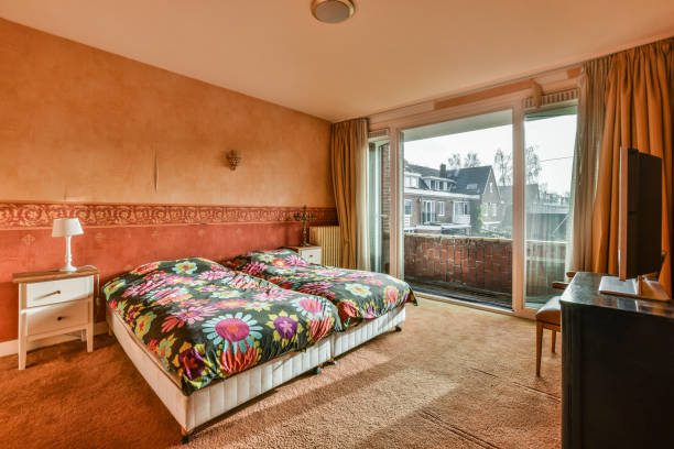 istock a hotel room with a bed and a large window 1464498871