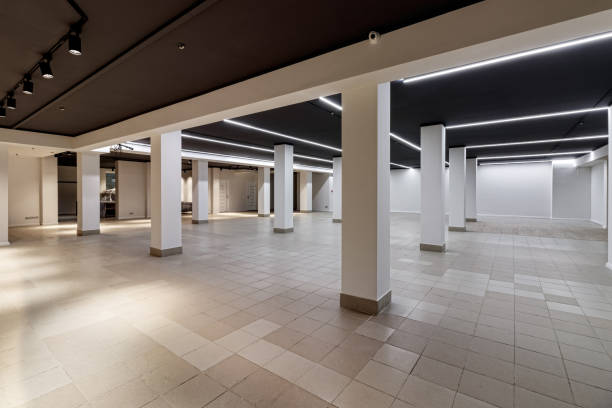 istock A large empty room with ceramic tiles on the floor, a black ceiling with lighting and columns propagating the ceiling 1464499606