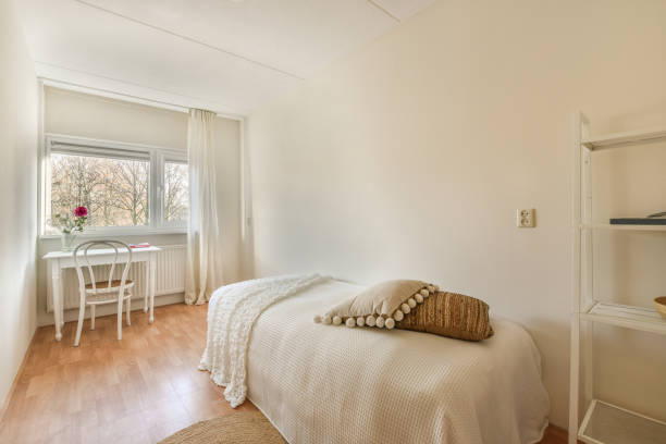 istock a bedroom with a bed and a desk and a 1464499641