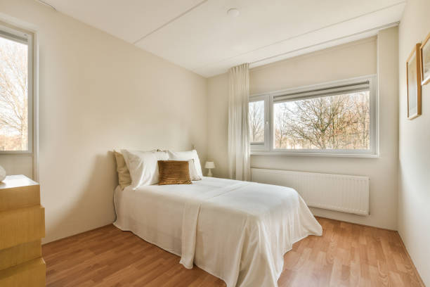 istock a bedroom with a bed and a window 1464500792
