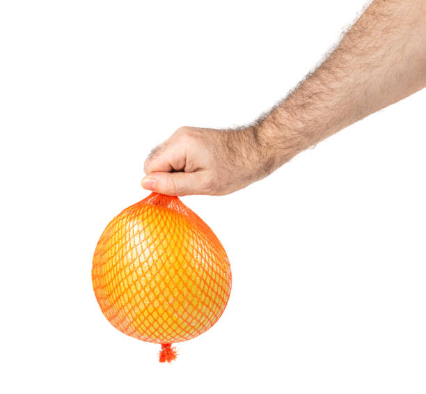 istock Pomelo Fruit in Plastic Mesh Packaging Isolated on White, Yellow Whole Pomelo on White Background, Clipping Path 1464501142