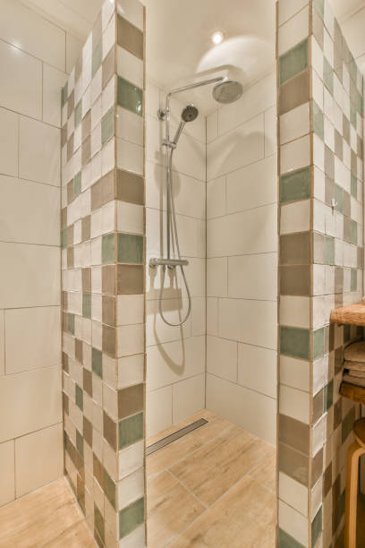 istock a shower in a white tiled bathroom with wood 1464501304