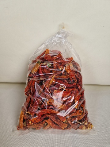 Dried spicy chilli peppers packed in a plastic bag.