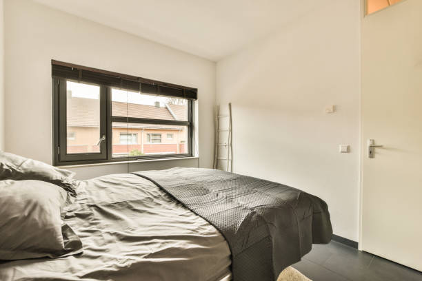 istock a bedroom with a bed and a window 1464502138
