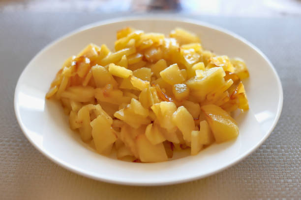 Close up of the fried potatoes in a white plate on the table