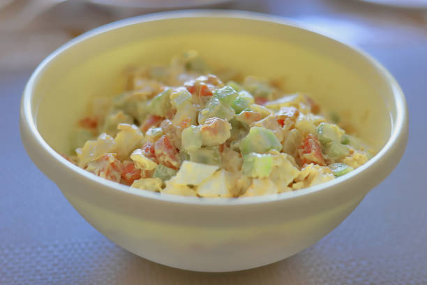istock Vegetable salad with mayonnaise sauce in a white plate on the table 1464502360