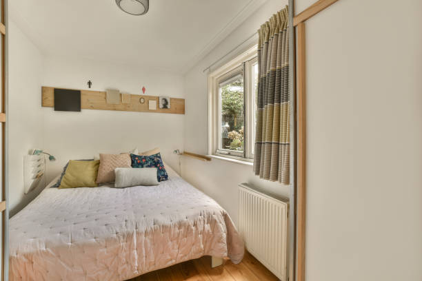 istock a bedroom with a bed and a window 1464502373
