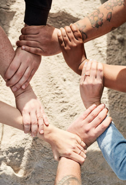 istock Community, beach sand or hands with support, trust or diversity standing together as a group in nature. Collaboration, team work or people in partnership with faith, goals or hope outdoors in summer 1464504376