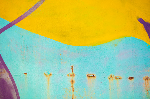 Part of abstract gravity multicolored with bright strokes. Painted concrete wall.