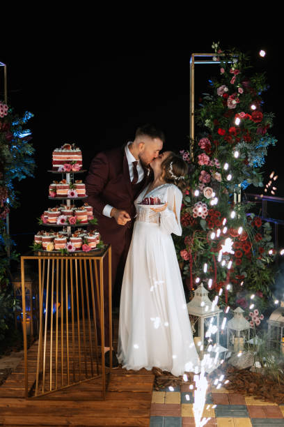 istock newlyweds happily cut and taste the wedding cake 1464504774