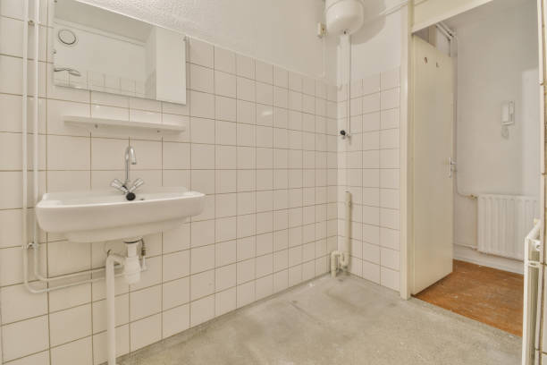 istock a white tiled bathroom with a sink and shower 1464504838