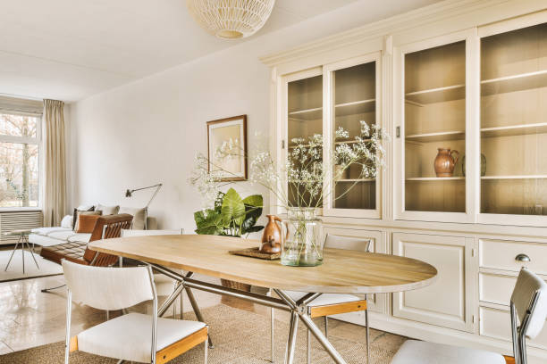 a dining room with a wooden table and white chairs