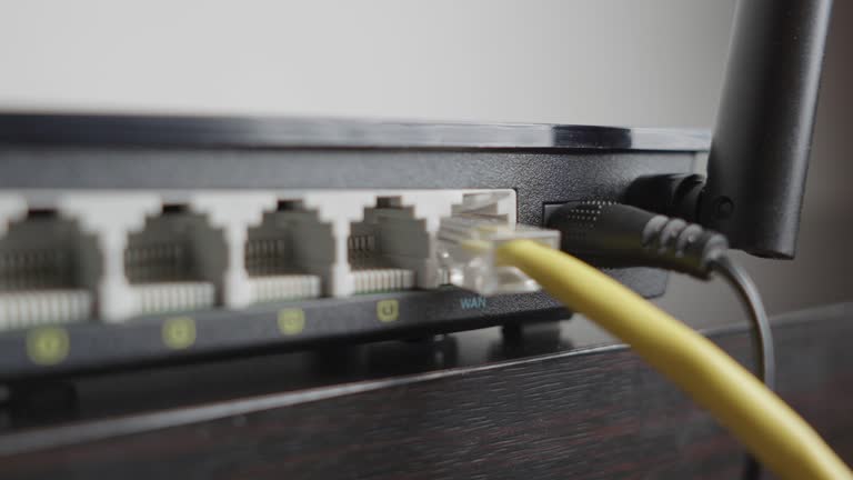 Man plugging in a WiFi router. Extreme close up