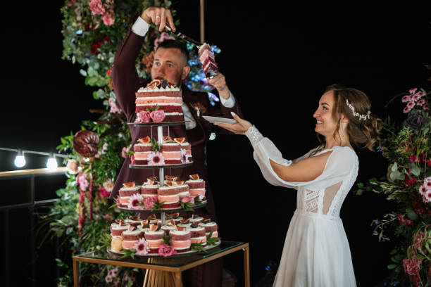 istock newlyweds happily cut and taste the wedding cake 1464506964