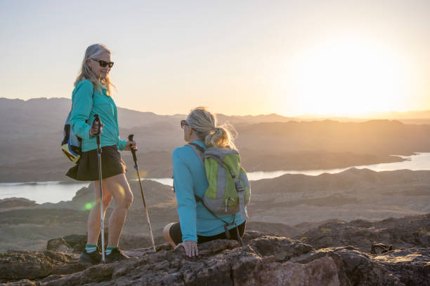 istock Mature female hikers relax on mountain summit 1464507860