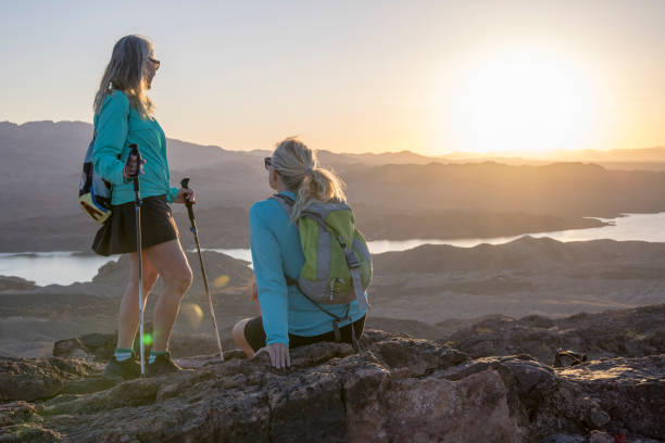istock Mature female hikers relax on mountain summit 1464507902