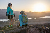 Mature female hikers relax on mountain summit