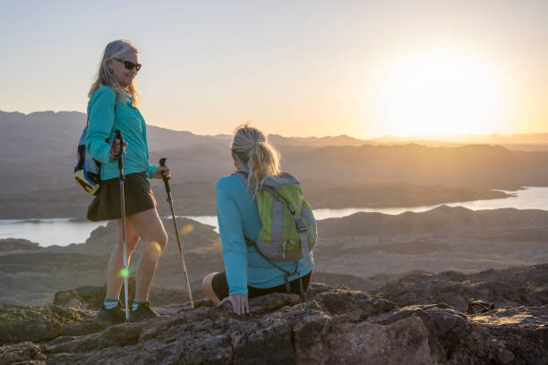 istock Mature female hikers relax on mountain summit 1464507935