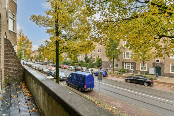 istock a blue van parked on the street next to a 1464508083