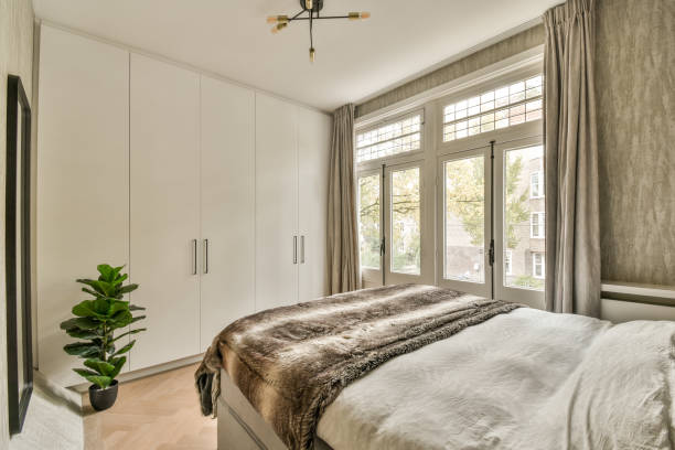istock a bedroom with a bed and white cabinets 1464508189